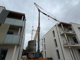 a crane that is standing on top of a building