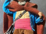 a toy of a man with a hat and a jacket on