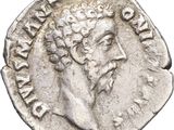 a close up of a silver coin with a man ' s face on it