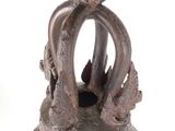 a metal bell with a crown on top of it