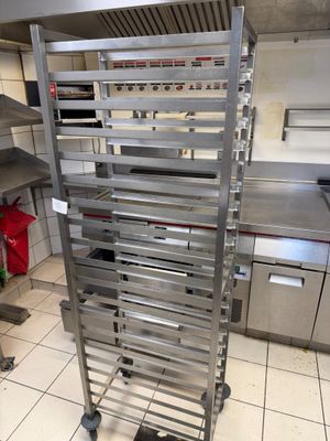 a metal rack that has a bunch of trays on it