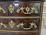 a brown dresser with gold decorations on it