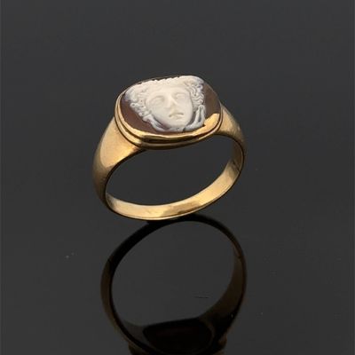 an image of a gold ring with a roman coin in the center
