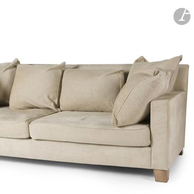 an image of a beige couch with pillows on it