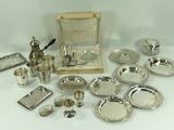a table with a lot of silver items on it