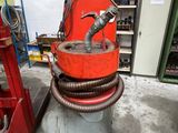 a red machine that is sitting in a garage