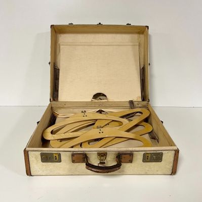 a suitcase with a bunch of wooden spoons inside of it