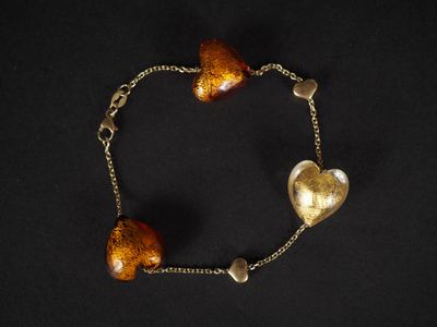 un gros plan sur un bracelet orné de deux cœurs