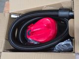 a red blow dryer sitting in a cardboard box