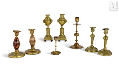 many different types of brass candlesticks on a white background