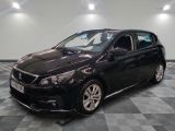 the black car is parked on a checkered floor in the garage
