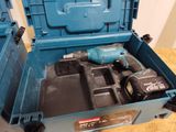 a blue tool box with tools in it on a table