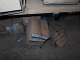 a pile of boxes sitting on the floor under a desk