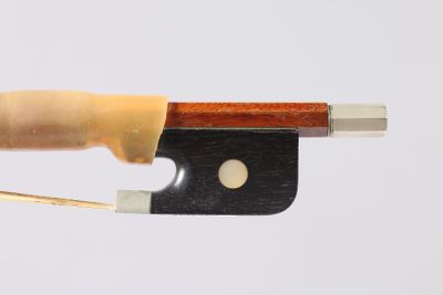 quelqu'un tient un couteau dont dépasse un morceau de bois