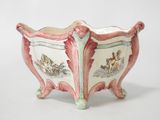 a pink and green planter with a horse and carriage design