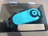 a blue water bottle in a cardboard box on the floor