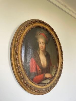 a painting of a woman in a red dress on the wall