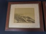 two framed photographs of a mountain and a road in a wood frame