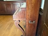 a wooden cabinet with a drawer on it in the corner of a room