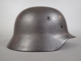 an old helmet with a hole in the middle of it