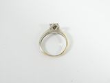 a close up of a ring with a diamond on it