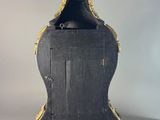 a black and gold clock sitting on a table
