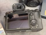 a camera that is sitting on a table next to a dvd