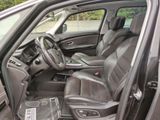 the interior of a car with the door open and the driver ' s seat down