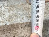 a person holding a measuring tape in front of a car