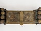 an old brass plate with a bunch of grapes on it
