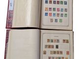 an open book with stamps on it sitting on top of a table