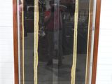 a display case with a wooden frame and a glass door