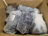 a cardboard box filled with bags of plastic material