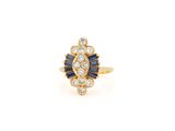 an 18k yellow gold ring with sapphire and diamonds