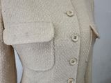 the back of a white sweater with buttons on a mannequin mannequin mannequin mannequin mannequin mannequin mannequin mann