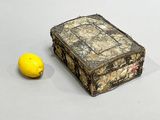 a small box with a lemon next to it
