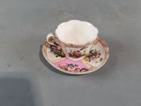 a small cup and saucer sitting on a table