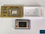 a game and a watch sitting next to each other on a table