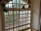 two lamps that are sitting on a window sill