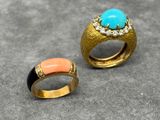 two gold rings with turquoise and coral stones on them