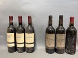 six bottles of wine are lined up on a table