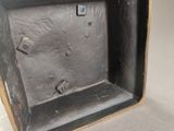 a close up of a metal object on a white surface