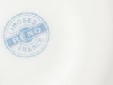 a white plate with a blue stamp on it