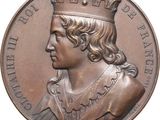 une image représentant une médaille de bronze à l'effigie d'un homme coiffé d'une couronne