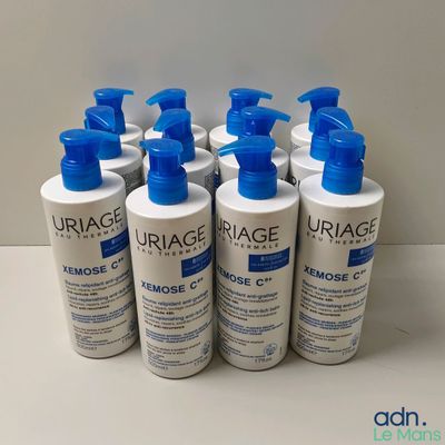 quatre flacons de nettoyant Uriage Xémose posés sur une table