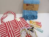 a red and white striped bag, a pair of flip flops, a towel, a pair of flip flops, and a pair of flip flop