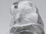 a glass figurine of a cat sitting on top of a table