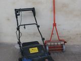 a blue and black lawn mower next to a red broom