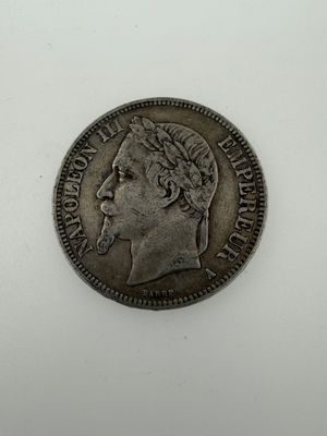 a silver coin with a woman ' s head on it