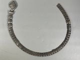 a close up of a silver bracelet with a snake on it